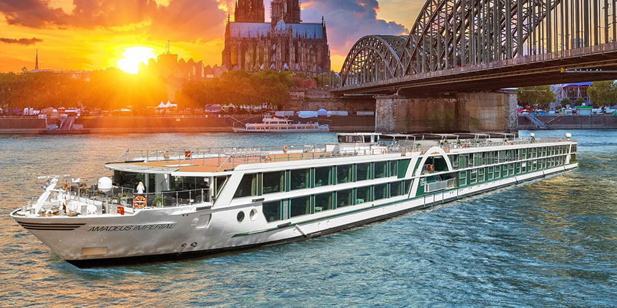 River cruise boat on river at sunset