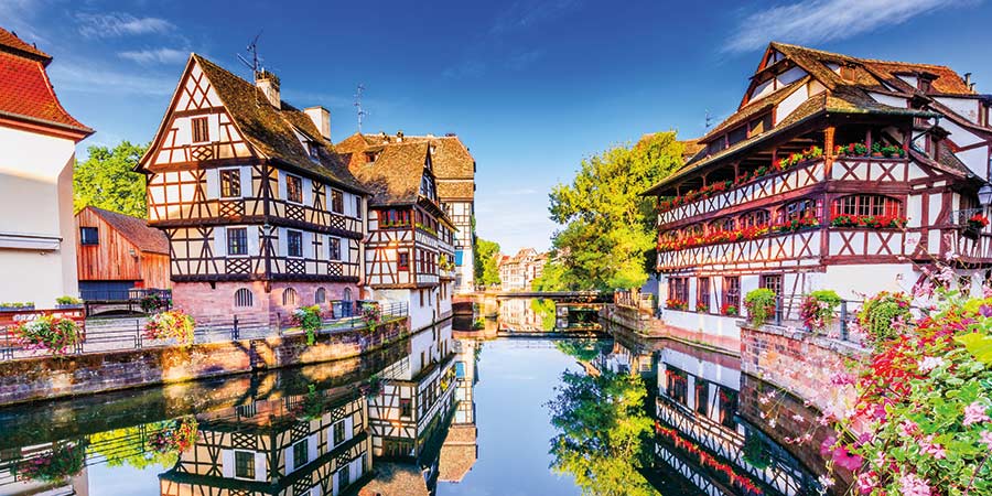 The traditional half-timbered houses of Strasbourg are surrounded by flowers.