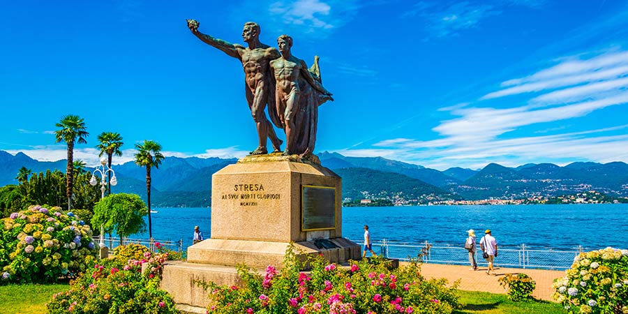 A statue stands in the middle of a lakeside park in Stresa, Italy.
