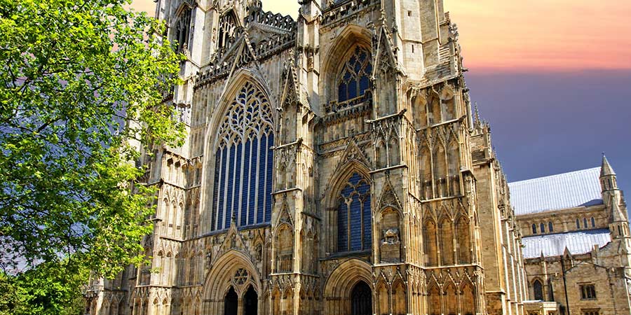 The striking York Minster features large glass windows and stone towers.