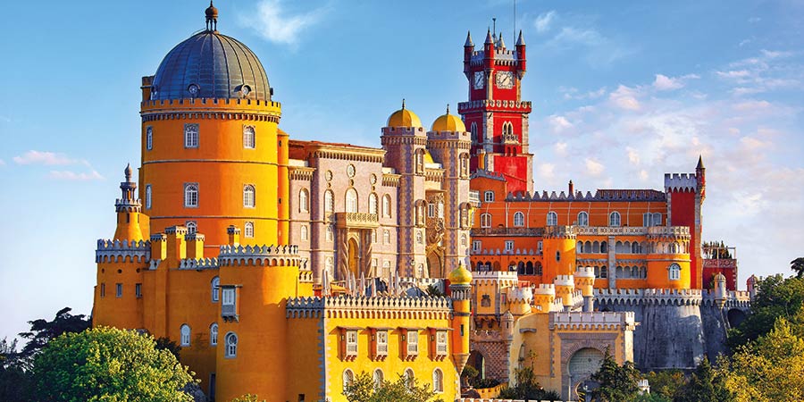Sintra’s palace features ornate architecture and is painted in bright hues of yellow and red.
