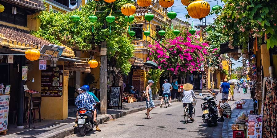 The picturesque streets of Hoi An are decorated with colour lanterns and flowers, and are full of both locals and tourists.