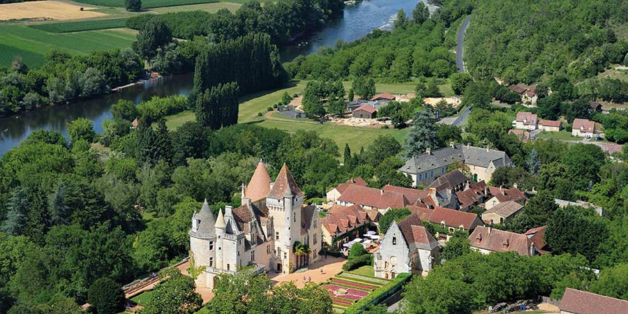 The fairytale castle Château des Milandes is surrounded by lush greenery and the Dordogne river that runs beside it.