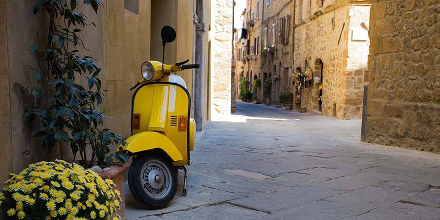 scooter standing at the empty street of old italian town scooter standing at the empty street of old italian town